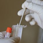 a laboratory expert takes a covid-19 swab test